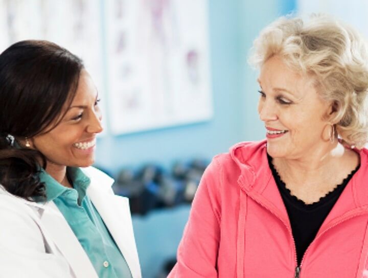 older woman smiling with doctor