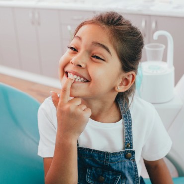 Child smiling in dentist's chair