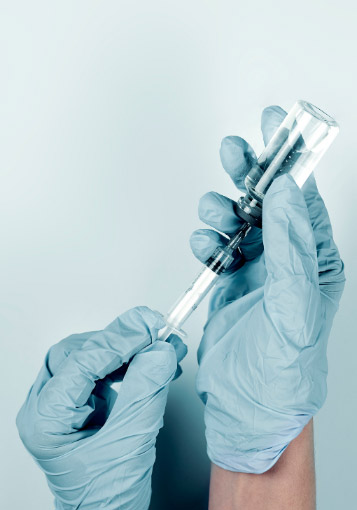 Doctor filling a syringe with a vaccine