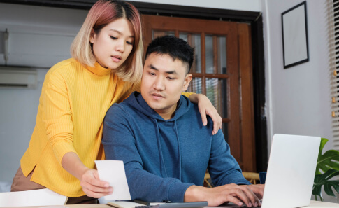 young couple looking at budget together